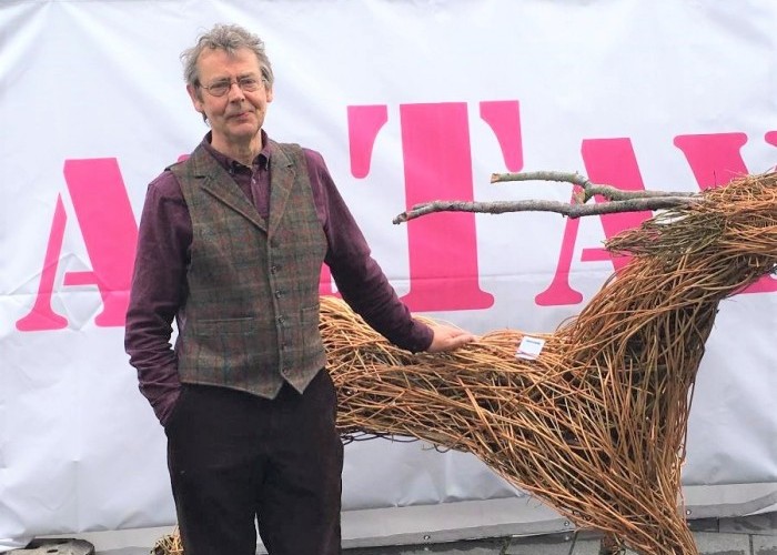 Hugh Goring Perth owner of Frames Gallery and organiser of arTay standing outside the tent next to a wicker deer.
